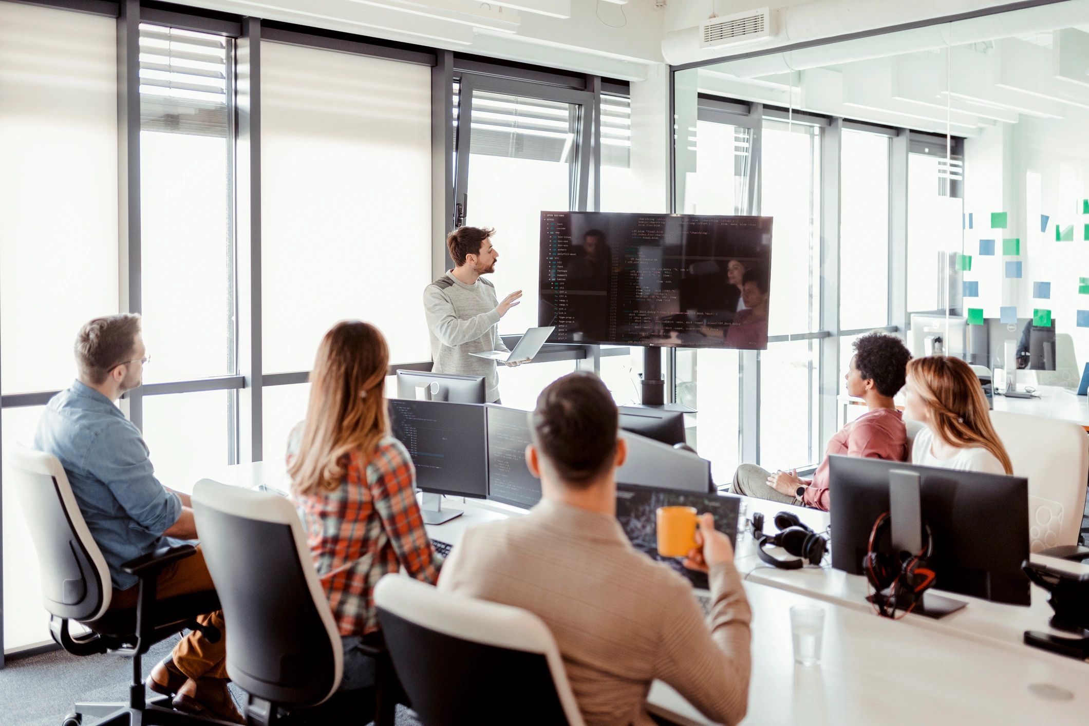 Team discussing implementation details in a modern office